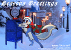 Foxee in a scarf and knit hat mailing a letter to Santa Claus before Christmas in a scenic snow-covered holiday decorated town.